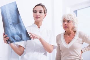 doctor patient shows an x-ray of the spine